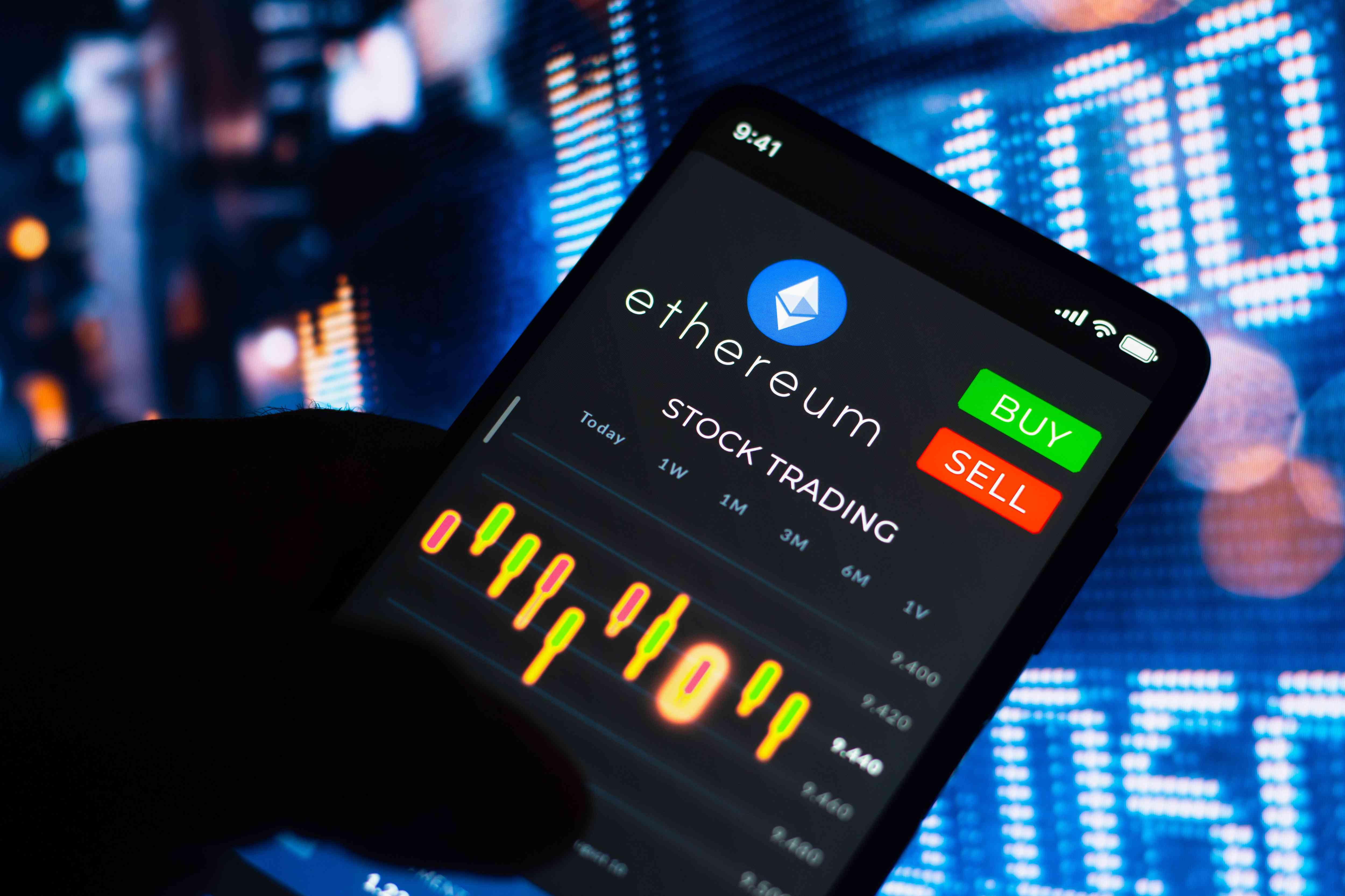 A close up of a mobile device showing a trading screen with ethereum.